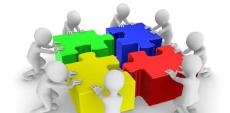 A Multidimensional Approach People working as a team with colored jigsaw puzzle. 3d illustration.